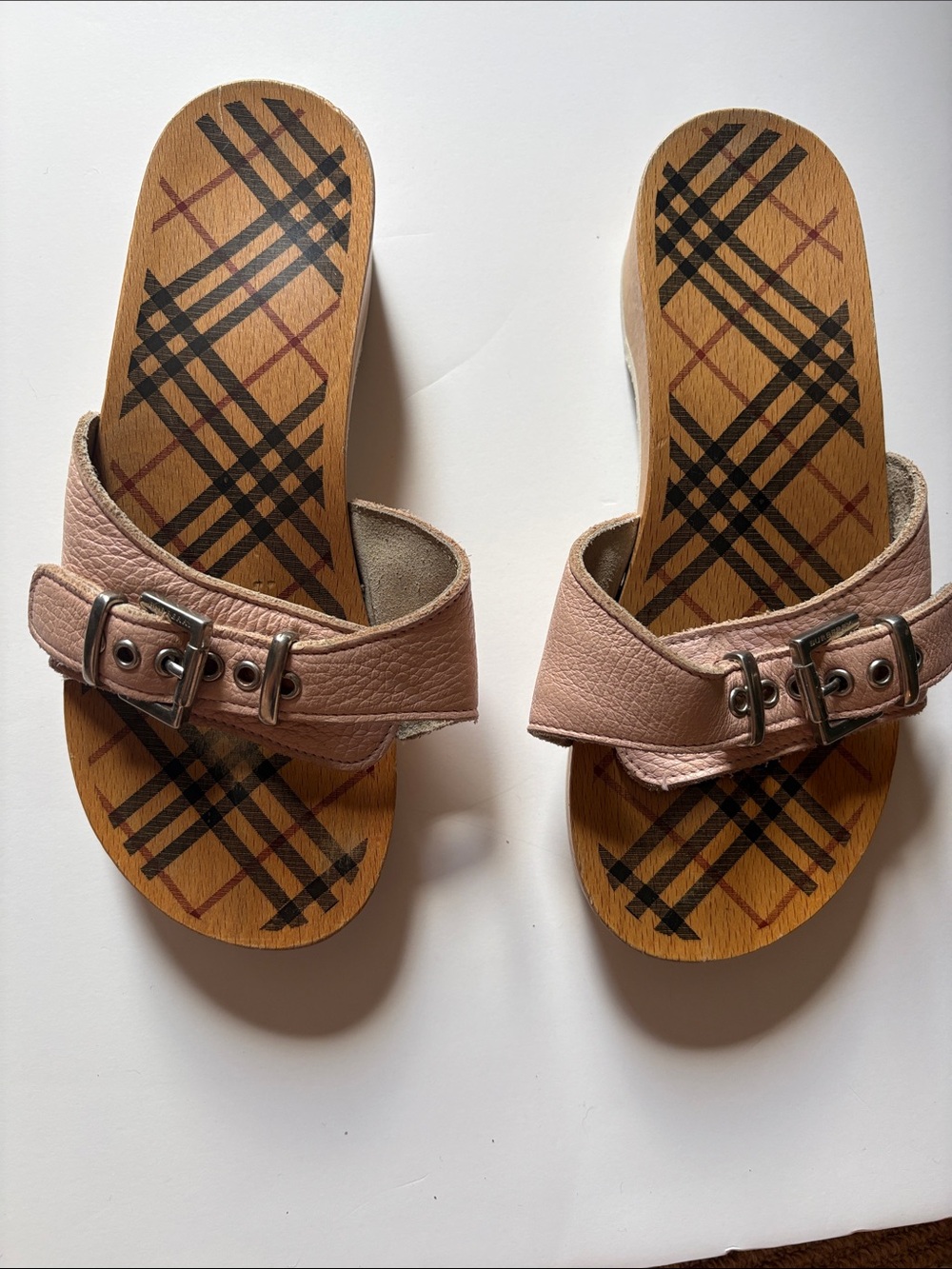 Burberry  Wooden and leather clogs.